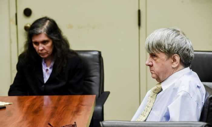 Defendants David Turpin, right, and wife, Louise, appear in Riverside Superior Court during an information hearing on charges that include torture and child abuse in Riverside, Calif., on Aug. 3, 2018. (Watchara Phomicinda/The Orange County Register via AP)