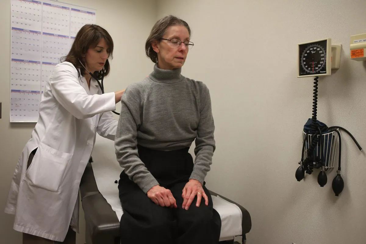 A doctor examines a patient complaining of flu-like symptoms at Northwestern Memorial Hospital on Jan. 10, 2013 in Chicago City.  (Scott Olson/Getty Images)