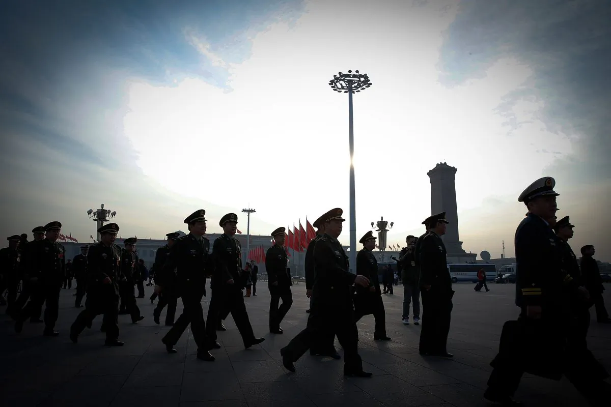 Chinese military officials arrive at the Great Hall of the People before a session of China's rubber-stamp legislature, the National People's Congress, in Beijing on March 12, 2015.  (Lintao Zhang/Getty Images)