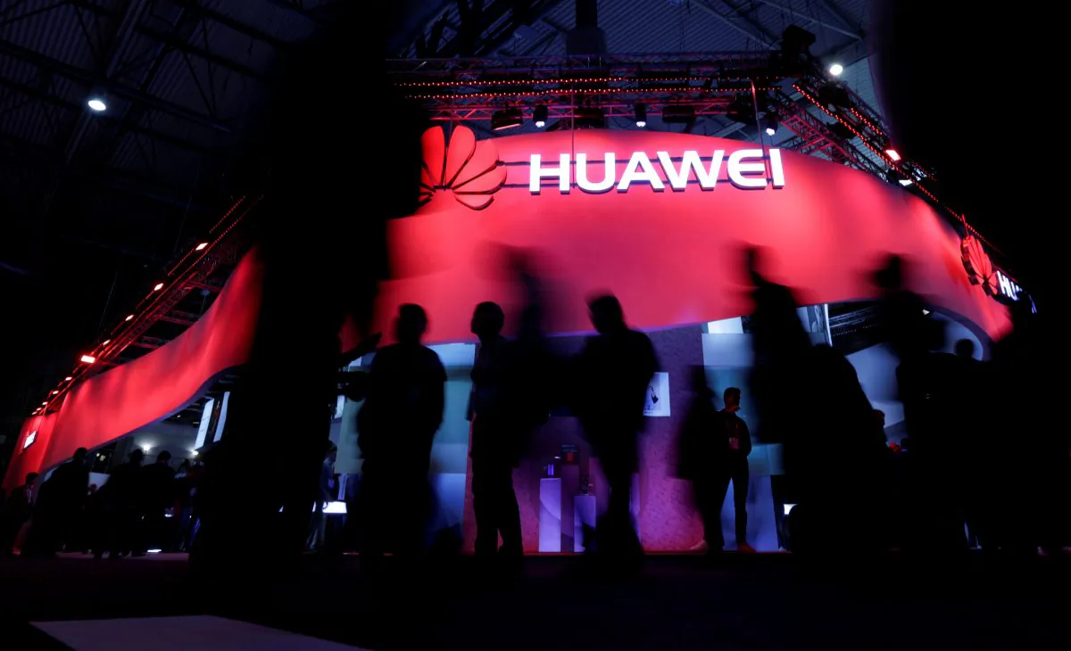 Visitors walk past Huawei's booth during Mobile World Congress in Barcelona, Spain on Feb. 27, 2017.  (Eric Gaillard/Reuters)