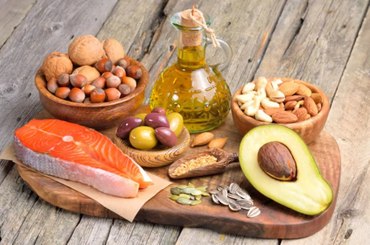 A mix of fats, such as those found in nuts, avocados, salmon and olives, could be healthy and more satisfying. (Craevschii Family/Shutterstock)