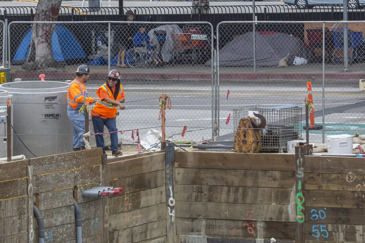Workers stand at the edge of a construction site in Los Angeles on May 1, 2017. (David McNew/Getty Images)