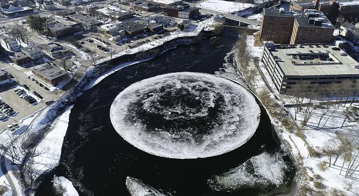 A naturally occurring ice disk forms on the Presumpscot River in this image taken from a drone video and provided by the City of Westbrook, Maine, on Jan. 14, 2019. (Tina Radel/City of Westbrook via AP)