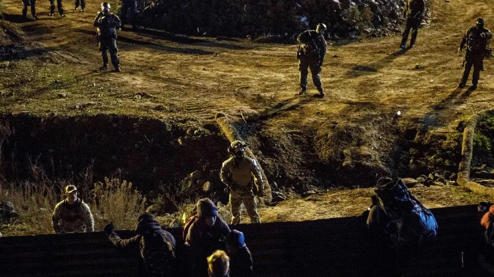 US border patrol officers deploy near the US-Mexico border fence to deter Central American migrants from crossing from Tijuana to San Diego, as seen from Tijuana, Baja California state, Mexico on Jan. 1, 2019. (Guillermo Arias/AFP/Getty Images)
