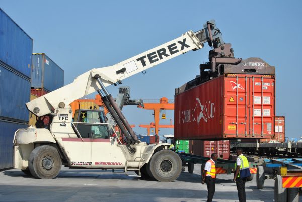 a crane is picking up cargo