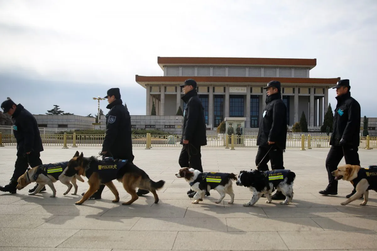Police walk sniffer dogs outside the Great Hall of the People during the Closing Session of the Chinese People's Political Consultative Conference (CPPCC) in Beijing, China on March 15, 2018. (Thomas Peter/Reuters)