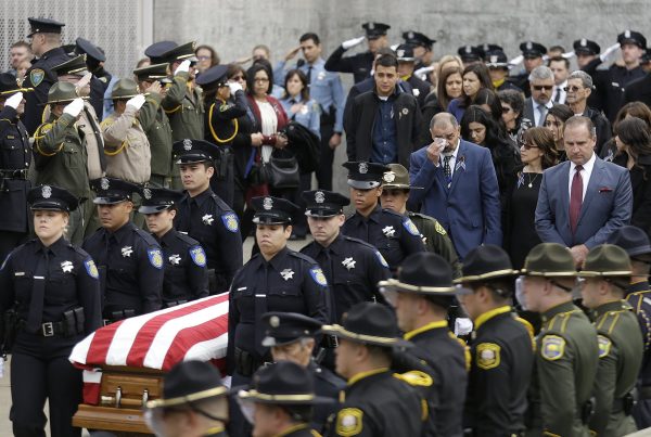 Family members follow the flag draped coffin of Davis Police Officer Natalie Corona