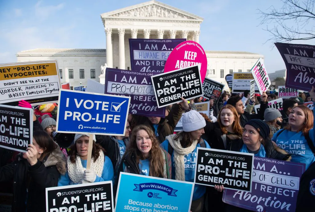 Pro-choice activists hold signs in response to anti-abortion activists participating in the "March for Life," an annual event to mark the anniversary of the 1973 Supreme Court case Roe v. Wade, which legalized abortion in the US, outside the US Supreme Court in Washington on Jan. 18, 2019. (SAUL LOEB/AFP/Getty Images)