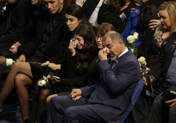 Merced Corona, father of Davis Police Officer Natalie Corona, foreground, and family members wipe their eyes