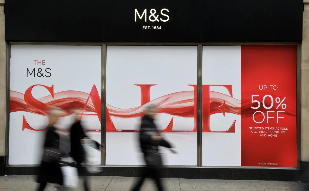 Shoppers walk past sale signs at a branch of the British clothing and food retailer Marks and Spencer on Oxford Street in London, Britain, on Jan. 3, 2019. (Toby Melville/Reuters)