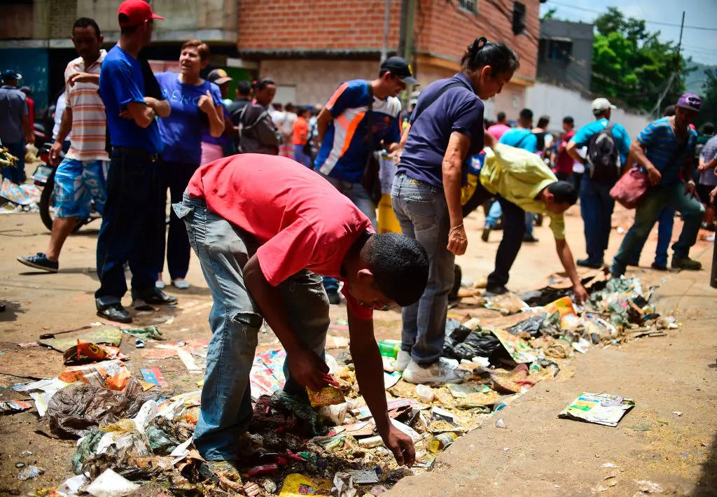 People look for food outside a looted supermarket at El Valle neighborhood, in Caracas, Venezuela, on April 21, 2017. (Ronaldo Schemidt/AFP/Getty Images)