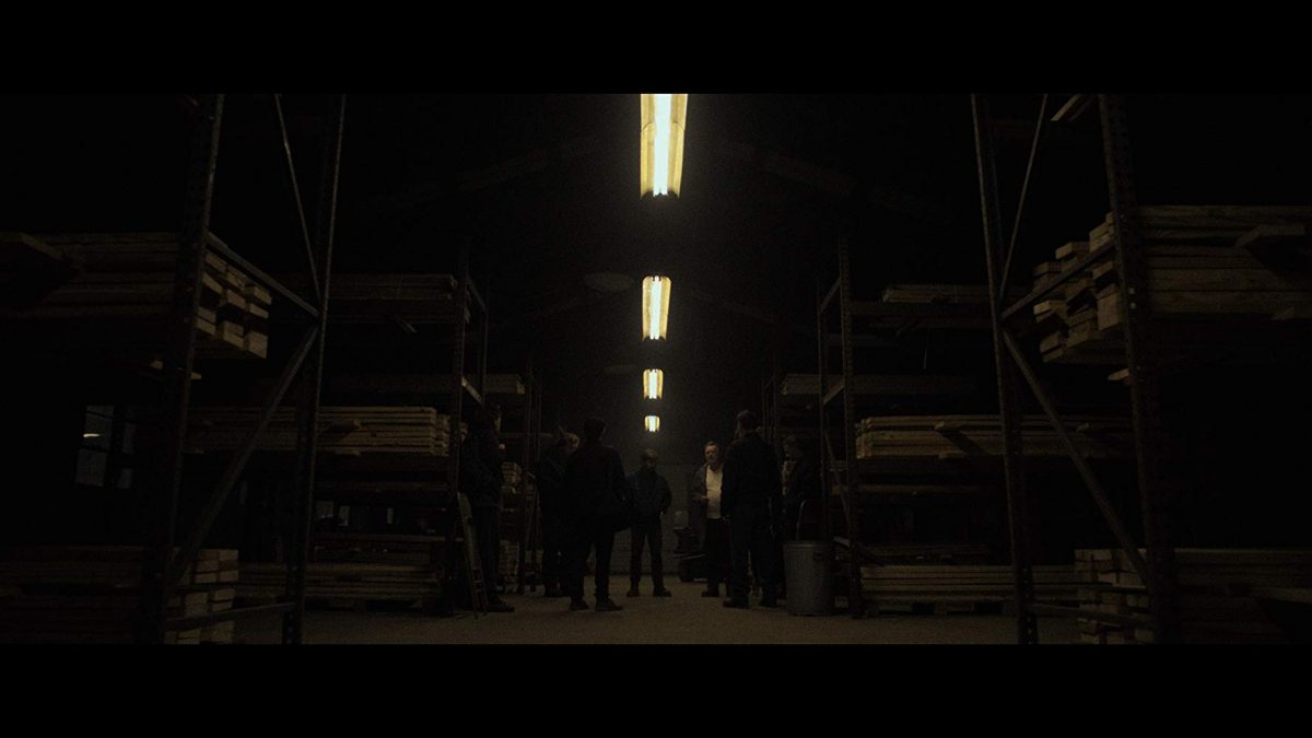 Militia meeting in a dark warehouse