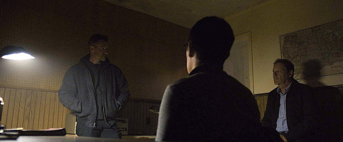 Three militia men in a dark room