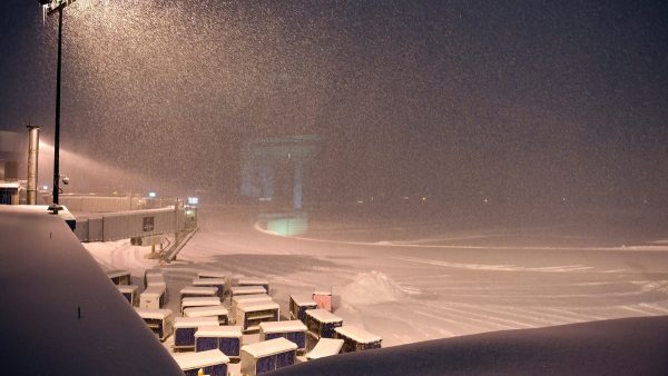 Airline baggage carts sit on the tarmac as crews prepare to remove snow at the Albany International Airport on Jan. 20