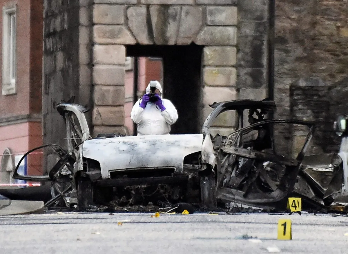 A forensic officer at the scene of a suspected car bomb in Londonderry, Northern Ireland, on Jan. 20, 2019. (Clodagh Kilcoyne/Reuters)