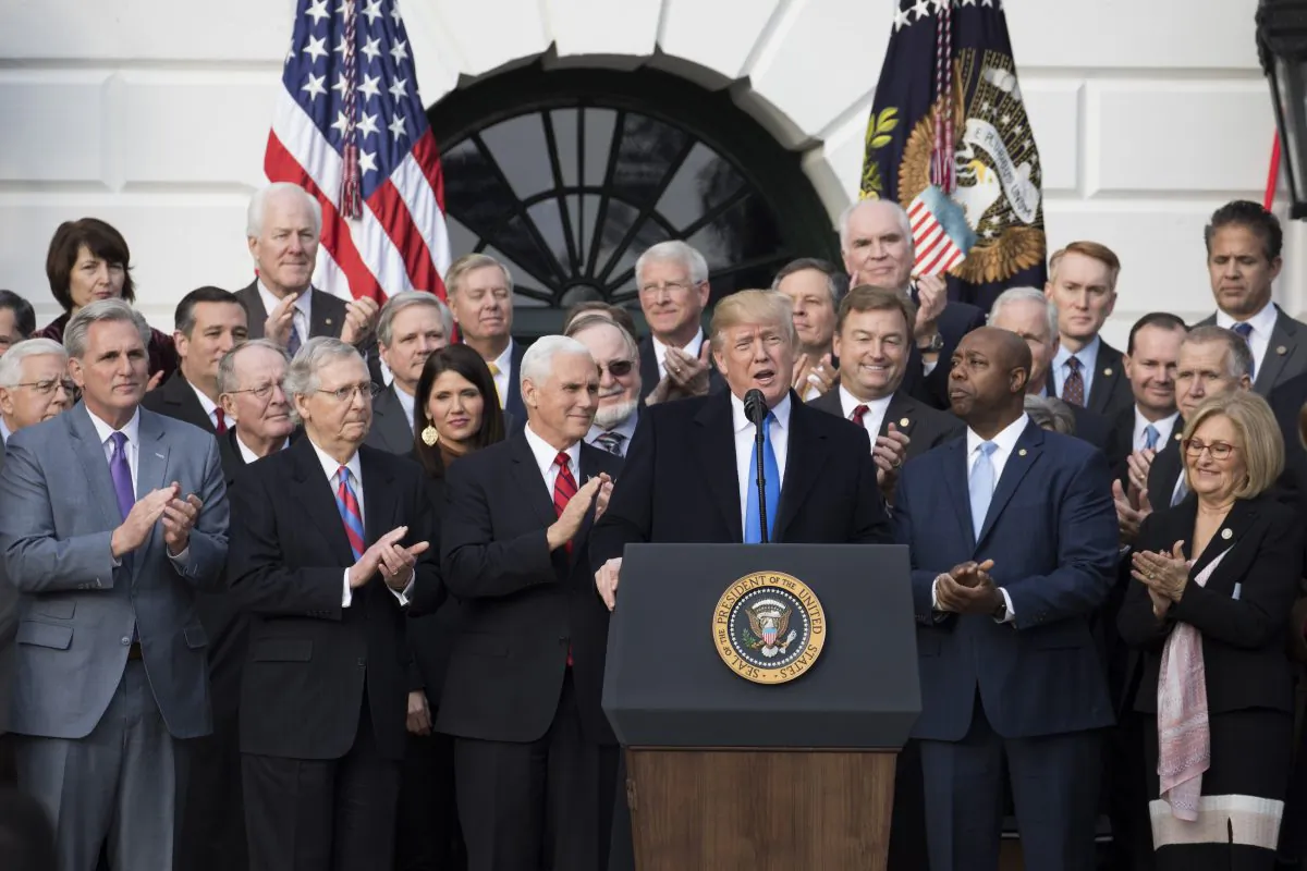 President Donald Trump and members of Congress celebrate the passage of the tax legislation in Washington on Dec. 20, 2017. (Samira Bouaou/The Epoch Times)
