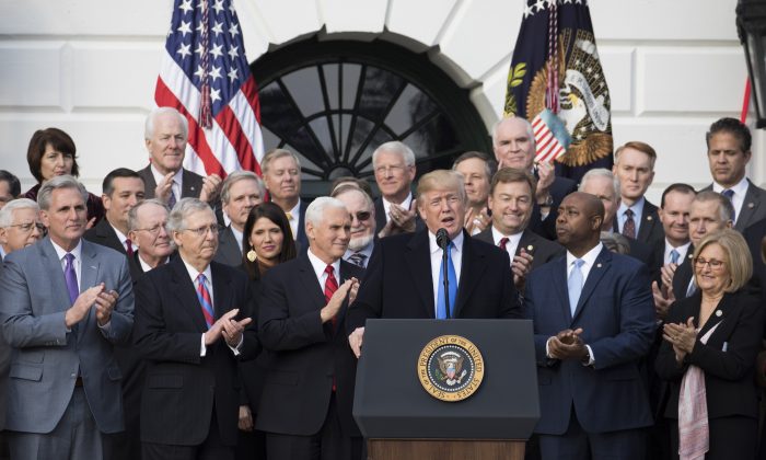 President Donald Trump and members of Congress celebrate the passage of the tax legislation in Washington on Dec. 20, 2017. (Samira Bouaou/The Epoch Times)