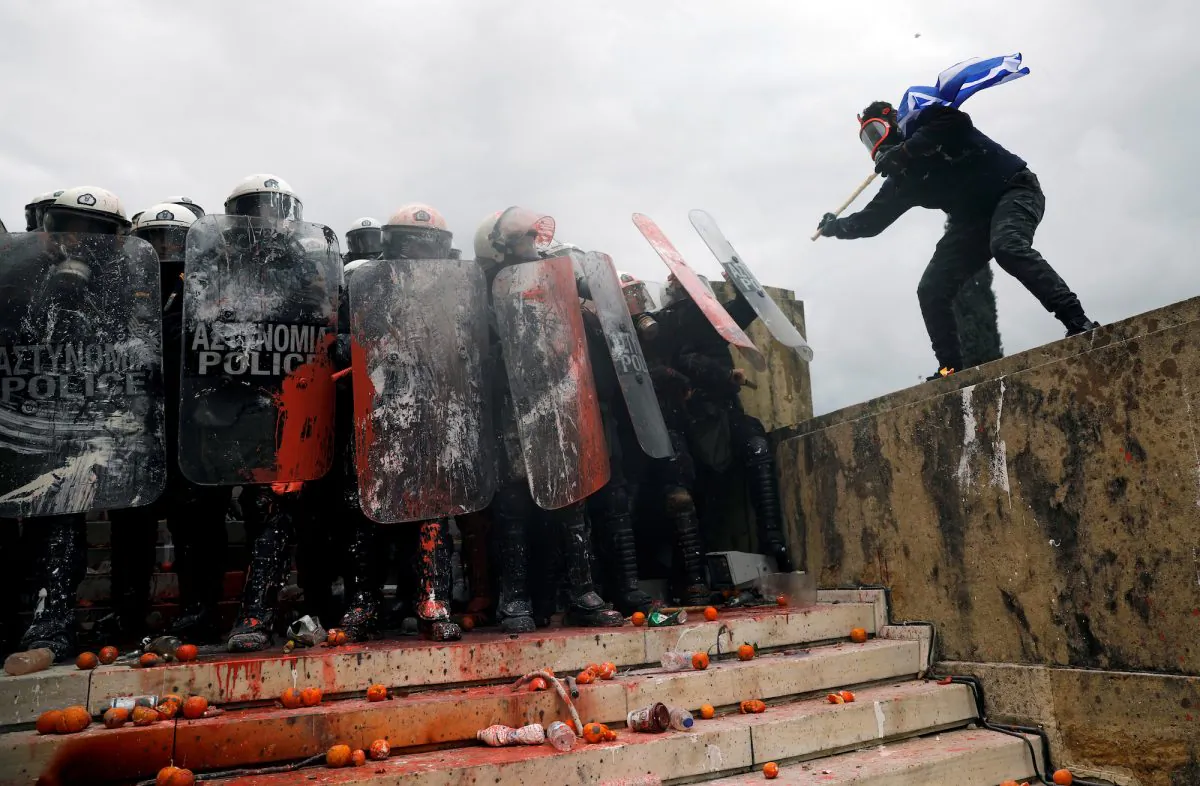 A protester approaches police officers during a demonstration in Athens, Greece, on Jan. 20, 2019. (Alkis Konstantinidis/Reuters)