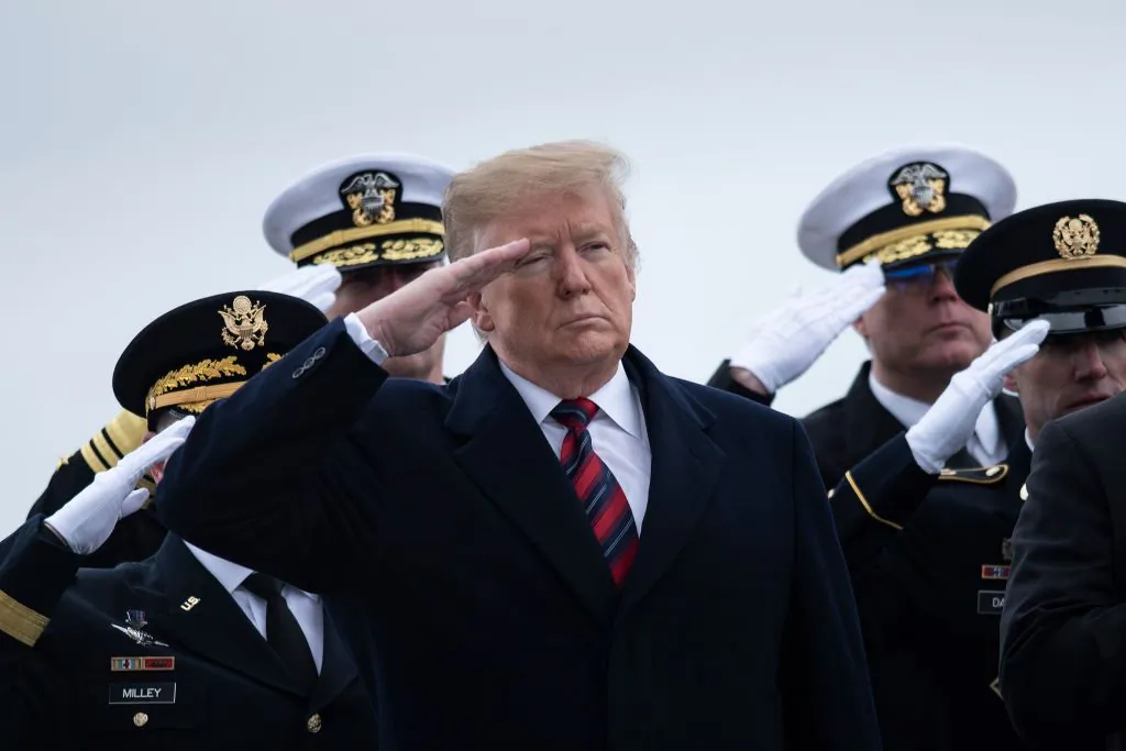 President Donald Trump and others pay their respects as the remains of Scott A. Wirtz, a Defense Intelligence Agency civilian and former Navy Seal, are carried by during a dignified transfer for U.S. personal killed in a suicide bombing in Syria at Dover Air Force Base in Dover, Delaware, on Jan. 19, 2019. (Brendan Smialowski/AFP/Getty Images)