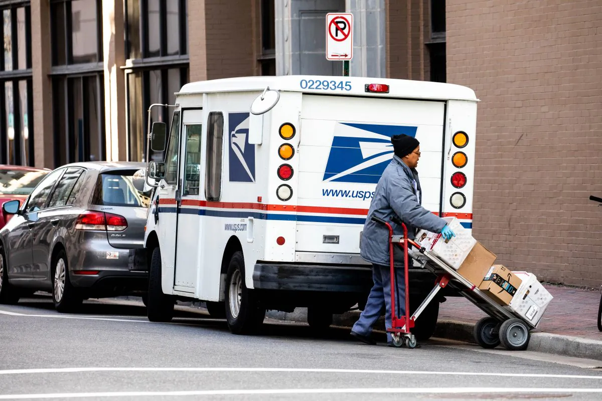 A woman unloads a USPS truck in Norfolk, Va., on Jan. 26, 2018. (Samira Bouaou/The Epoch Times)