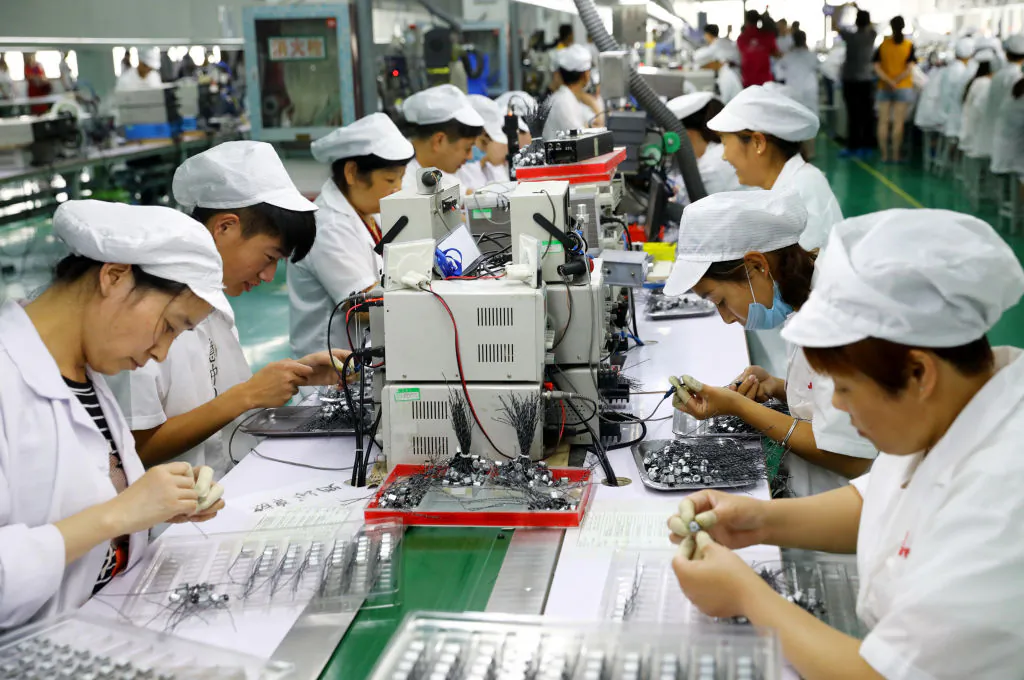 Employees work on a micro-motor production line at a factory in Huaibei in eastern China's Anhui Province, on June 23, 2018. (AFP/Getty Images)