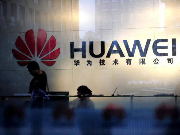 Staff and visitors walk pass the lobby at the Huawei office in Wuhan, central China's Hubei Province on Oct. 8, 2012. (STR/AFP/GettyImages)