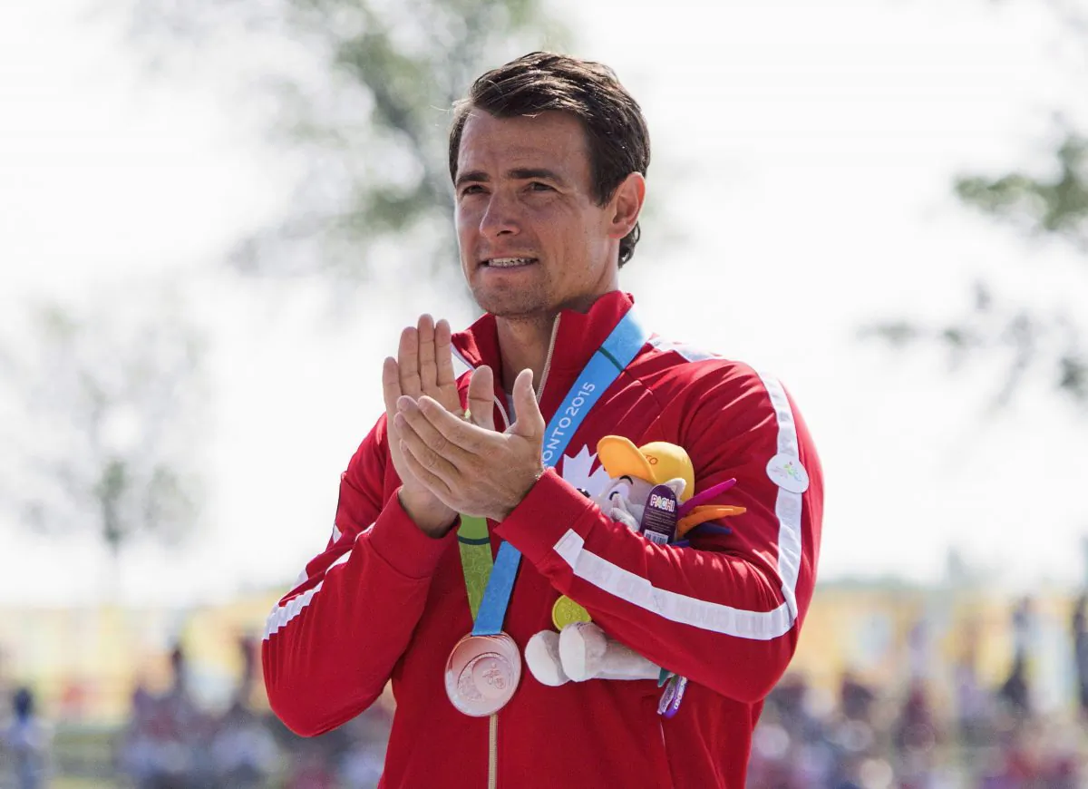 Canada's Adam van Koeverden accepts his bronze medal for the K1 1000m final at the 2015 Pan Am Games in Welland, Ont., on July 13, 2015. (The Canadian Press/Aaron Lynett)