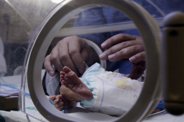 A nurse changes the diaper