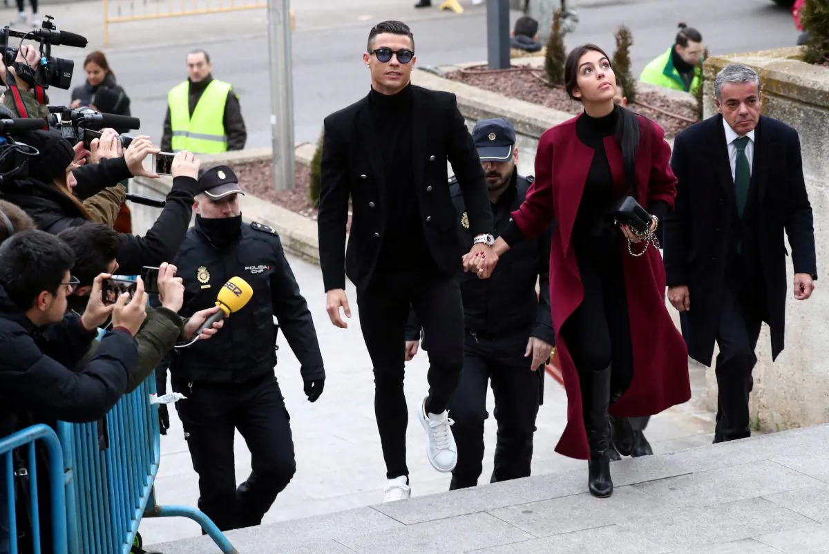 Soccer player Cristiano Ronaldo arrives with his girlfriend, Georgina Rodriguez, to appear in court on a trial for tax fraud in Madrid, Spain, Jan. 22, 2019. (Reuters/Sergio Perez)