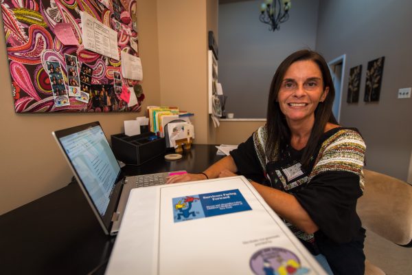 Tracy Vicere sits at her desk