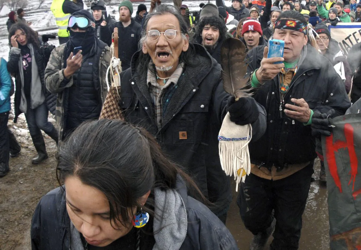 In this Feb. 22, 2017, file photo, Nathan Phillips, center with glasses, and other Dakota Access Pipeline protesters march in North Dakota. (Mike McCleary/The Bismarck Tribune via AP, File)