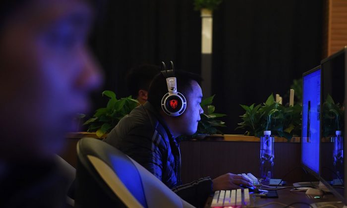 Men look at computers in an internet bar in Beijing on Dec. 16, 2015. (Greg Baker/AFP/Getty Images)