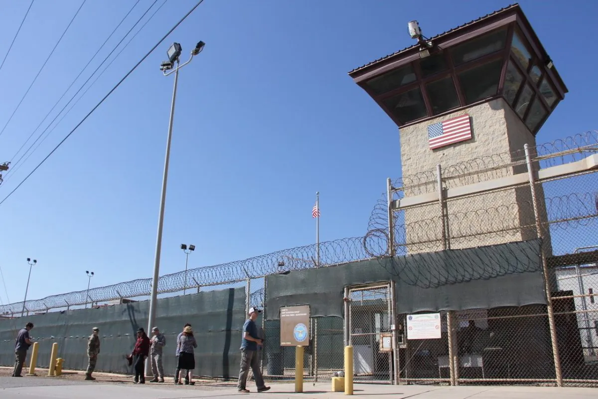 People walk past a guard tower outside the fencing of Camp 5 at the U.S. military prison in Guantanamo Bay, Cuba, on Jan. 26, 2017.
(THOMAS WATKINS/AFP/Getty Images)