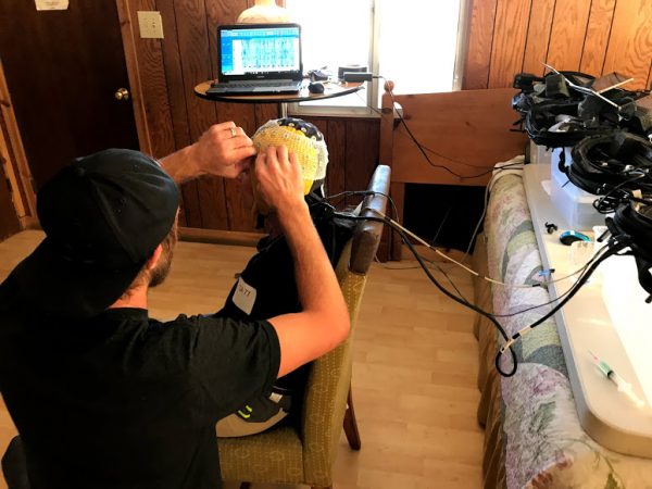 A participant is fitted with an EEG cap