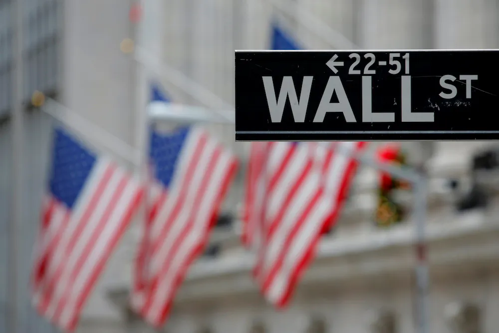 A street sign for Wall Street is seen outside the New York Stock Exchange in Manhattan, New York City, on Dec. 28, 2016. (Andrew Kelly/Reuters)