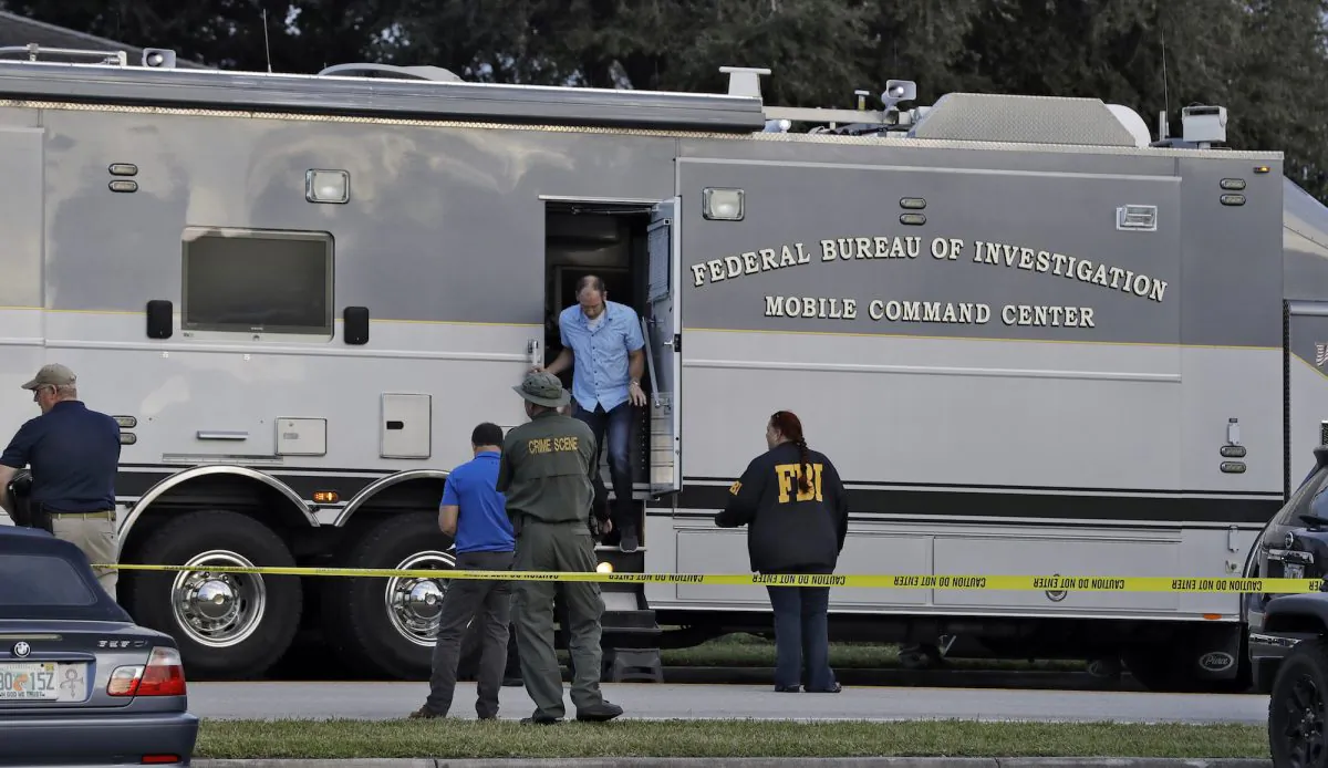 Law enforcement officials climb out a FBI mobile command center in Sebring, Fla, on Jan. 23, 2019. (Chris O’Meara/AP Photo)