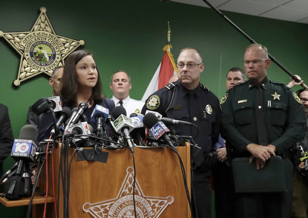 Florida Attorney General Ashley Moody addresses the media as she stands with Sebring Police Chief Karl Hoglund, center, and Highlands County Sheriff Paul Blackman during a news conference, in Sebring, Fla.
on Jan. 24, 2019.(AP Photo/Chris O'Meara)