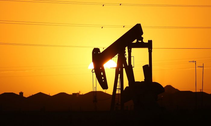 A pumpjack sits on the outskirts of town at dawn in the Permian Basin oil field in the oil town of Midland, Texas, on Jan. 21, 2016. (Spencer Platt/Getty Images)