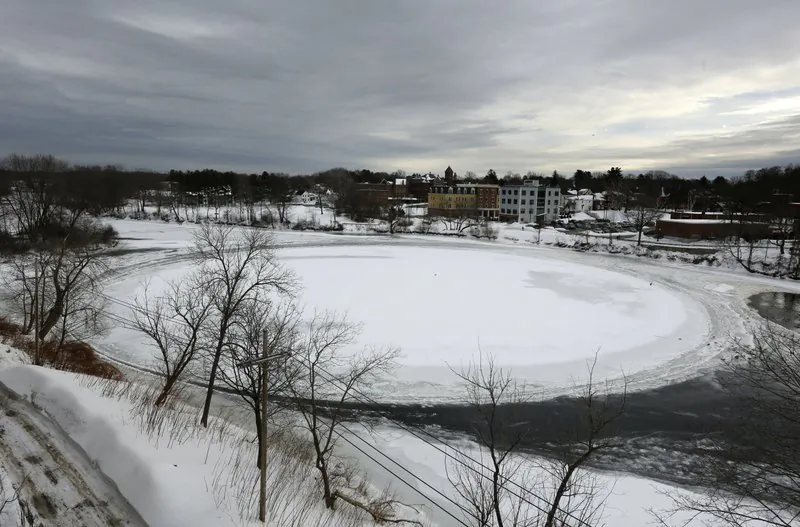 A naturally occurring ice disk that gained international fame appears to be freezing in place following a stretch of frigid weather, Jan. 23, 2019, in Westbrook, Maine. The giant ice disk on the Presumpscot River now has its own webcam. (AP Photo/Robert F. Bukaty)