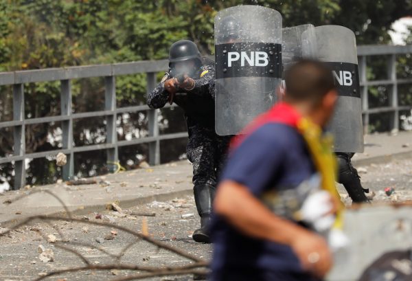 Police officer fires rubber bullets