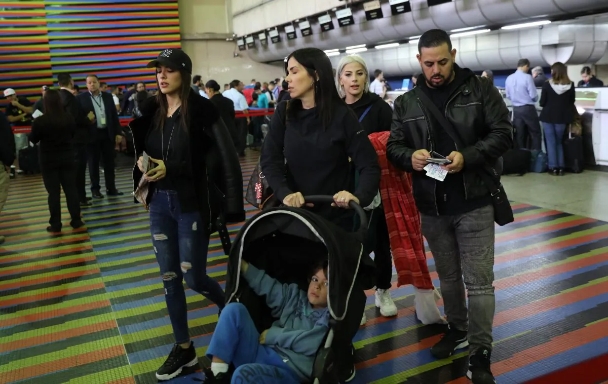 U.S. embassy employees and their families prepare to depart Simon Bolivar international airport in La Guaira, Venezuela, on Jan. 25, 2019. (Rodrigo Abd/AP Photo)