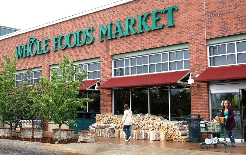 Customers leave the Whole Foods Market in Boulder, Colo., on May 10, 2017. (Rick Wilking/Reuters)