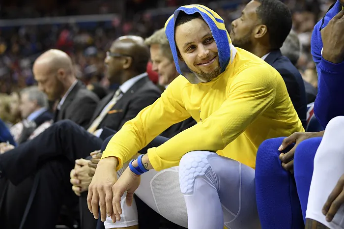 Golden State Warriors guard Stephen Curry smiles on the bench during the first half of the team's NBA basketball game against the Washington Wizards,in Washington, on Jan. 24, 2019. (Nick Wass/AP Photo)