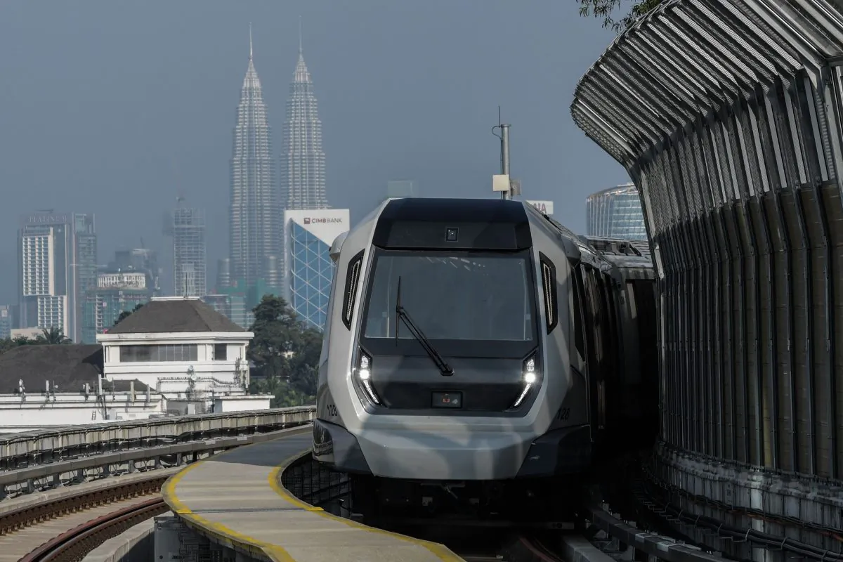 A Malaysia mass transit train against the backdrop of Malaysia's landmark Petronas Twin Towers, in Kuala Lumpur on December 15, 2016. (MOHD RASFAN/AFP/Getty Images)