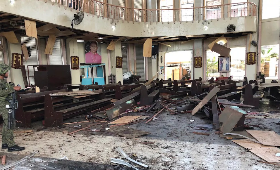 Armed forces of the Philippines, a soldier views the site inside a Roman Catholic cathedral in Jolo, the capital of Sulu province in the southern Philippines after two bombs exploded Jan. 27, 2019. (WESMINCOM Armed Forces of the Philippines Via AP)