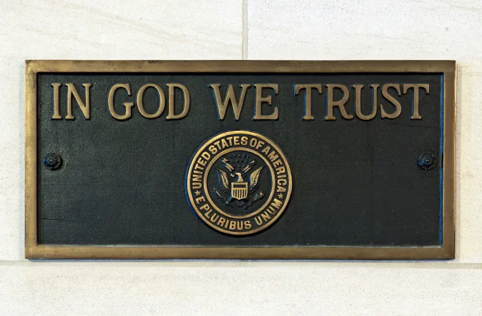 Two identical In God We Trust bronze plaques placed in 1961 at: (1) Longworth House Office Building, main lobby, east wall. (2) Dirksen Office Building, southwest entrance, west wall. (USCapitol/Wiki Commons)