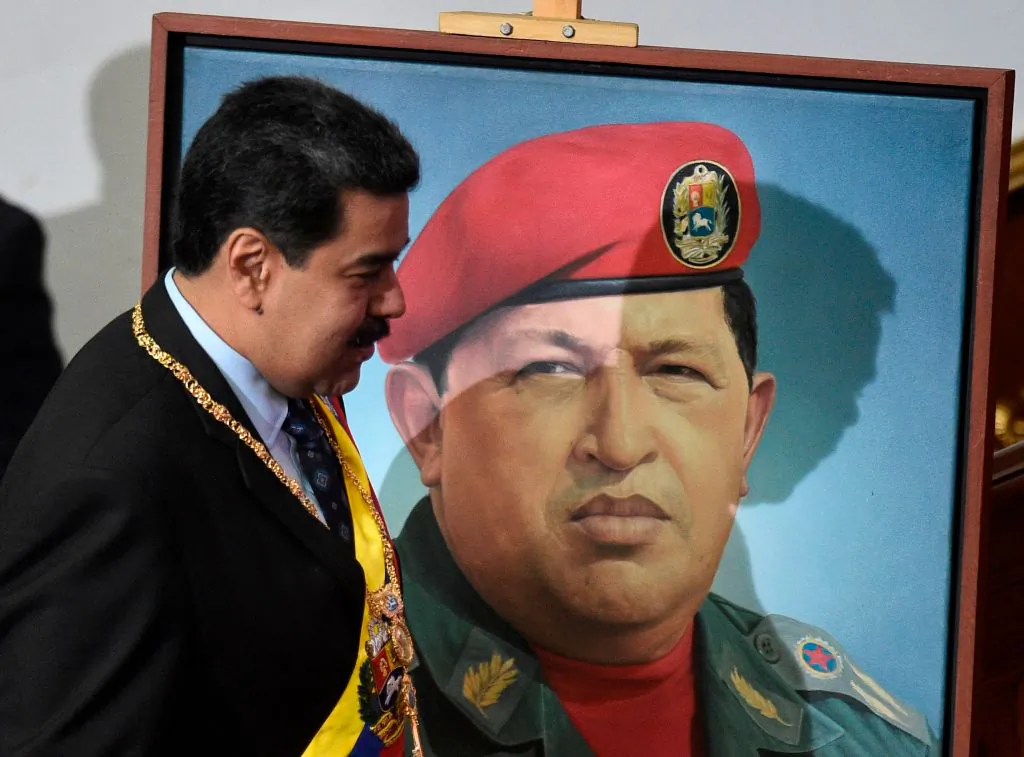 Venezuelan President Nicolas Maduro passes by a portrait of late Venezuelan President Hugo Chavez as he arrives to speak before the Constituent Assembly, at the Federal Legislative Palace in Caracas on Jan. 14, 2019. (Federico Parra/AFP/Getty Images)