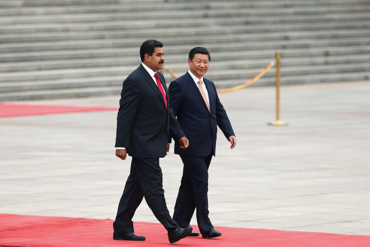 Chinese leader Xi Jinping (R) accompanies Venezuela's President Nicolás Maduro to view an honor guard during a welcoming ceremony outside the Great Hall of People in Beijing on Sept. 22, 2013. (Lintao Zhang/Getty Images)