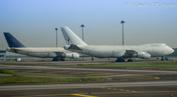 The same model of aircraft, Boeing 747, park at the Kuala Lumpur International Airport