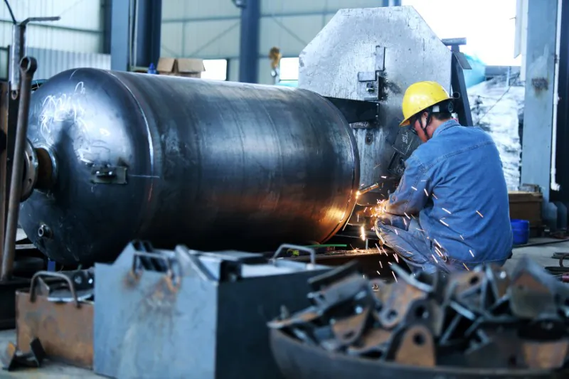 A worker welds a pressure vessel at a company manufacturing industrial equipment in Nantong, Jiangsu Province, China on June 19, 2018. (Reuters)